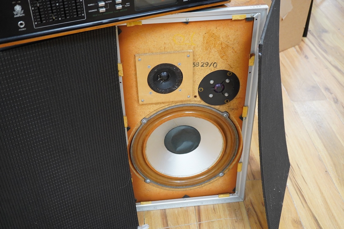 A Dynatron Goldring GL78 turntable with integral amplifier and tuner, made in Switzerland, together with a pair of Leak Sandwich 600 stereo speakers in teak cabinets, 65cm high